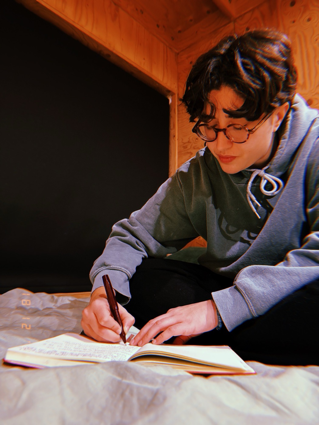 Dr Ella Whitcomb-Khan writing in a journal